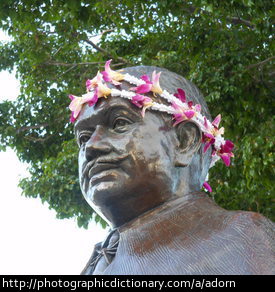 A statue adorned with flowers.