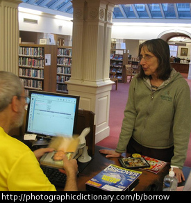 Photo of a woman borrowing some books