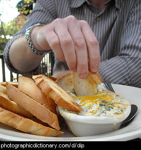 Photo of someone dipping bread