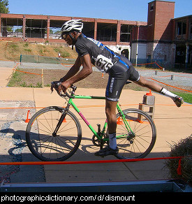 Photo of a man dismounting a bicycle