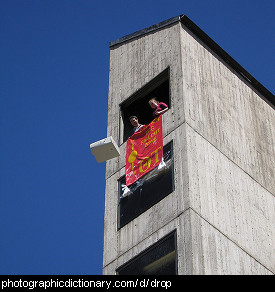 Photo of students dropping something out of a window