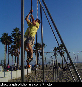 Photo of a man climbing a rope