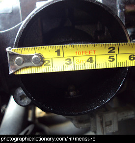 Photo of someone measuring a pipe