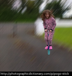 A girl using a pogo stick.