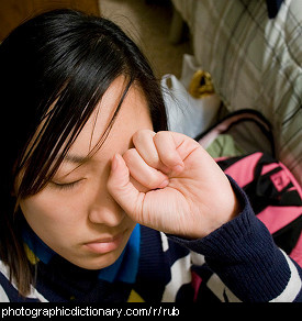 Photo of a woman rubbing her eyes