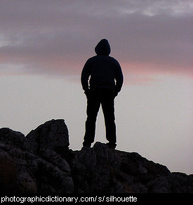 Photo of a young man in silhouette.