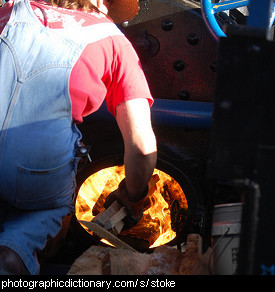 Photo of someone stoking a fire