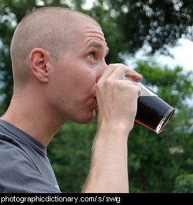 Photo of a man taking a swig of beer