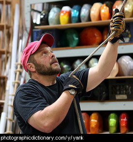 Photo of a man yanking a rope